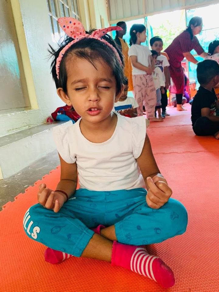 Child practicing a yoga pose